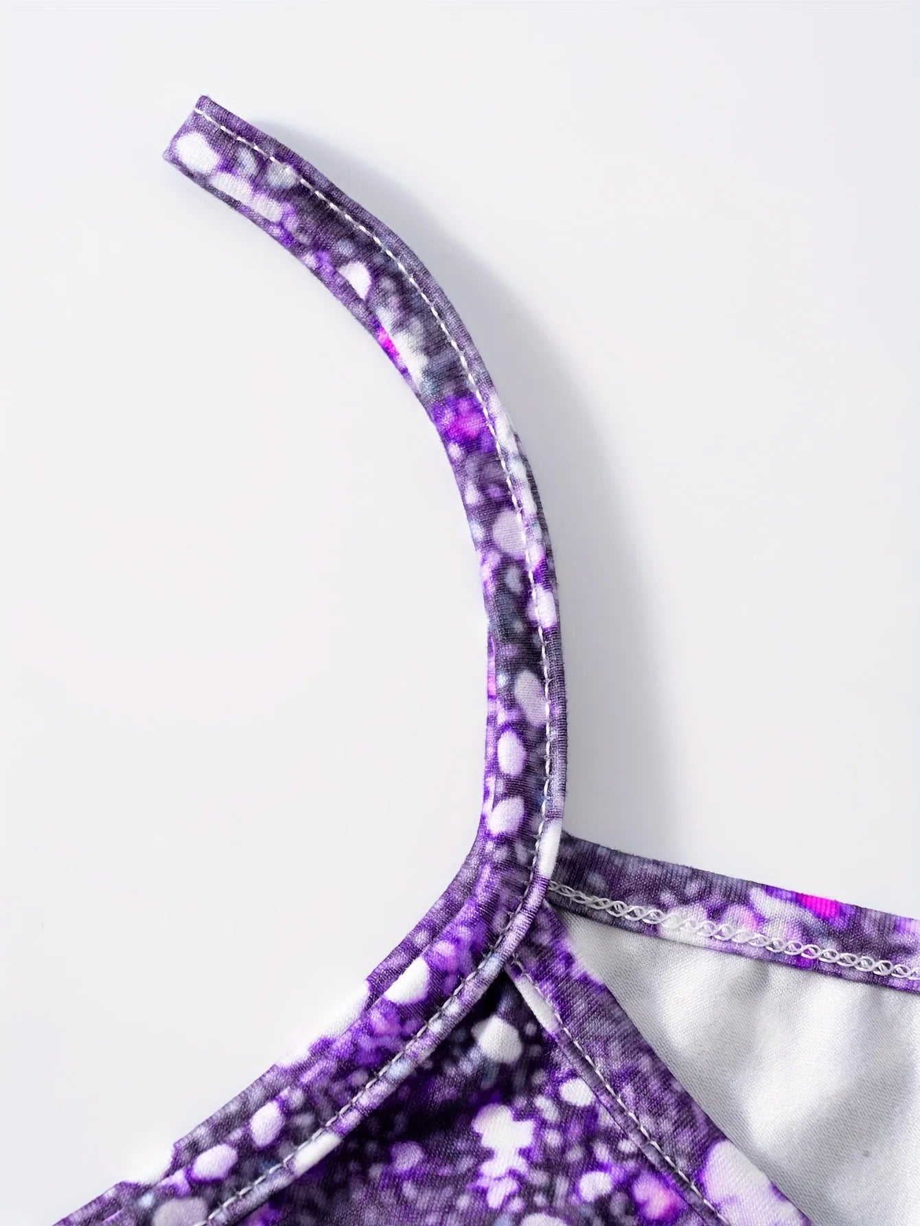 This round neck spaghetti strap maxi dress features a dazzling purple glitter, butterfly print on a sleek black base.