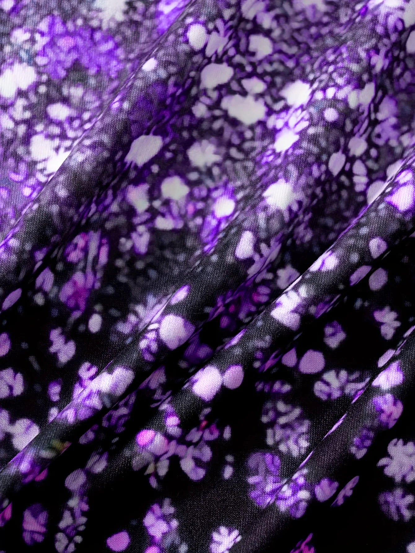 This round neck spaghetti strap maxi dress features a dazzling purple glitter, butterfly print on a sleek black base.